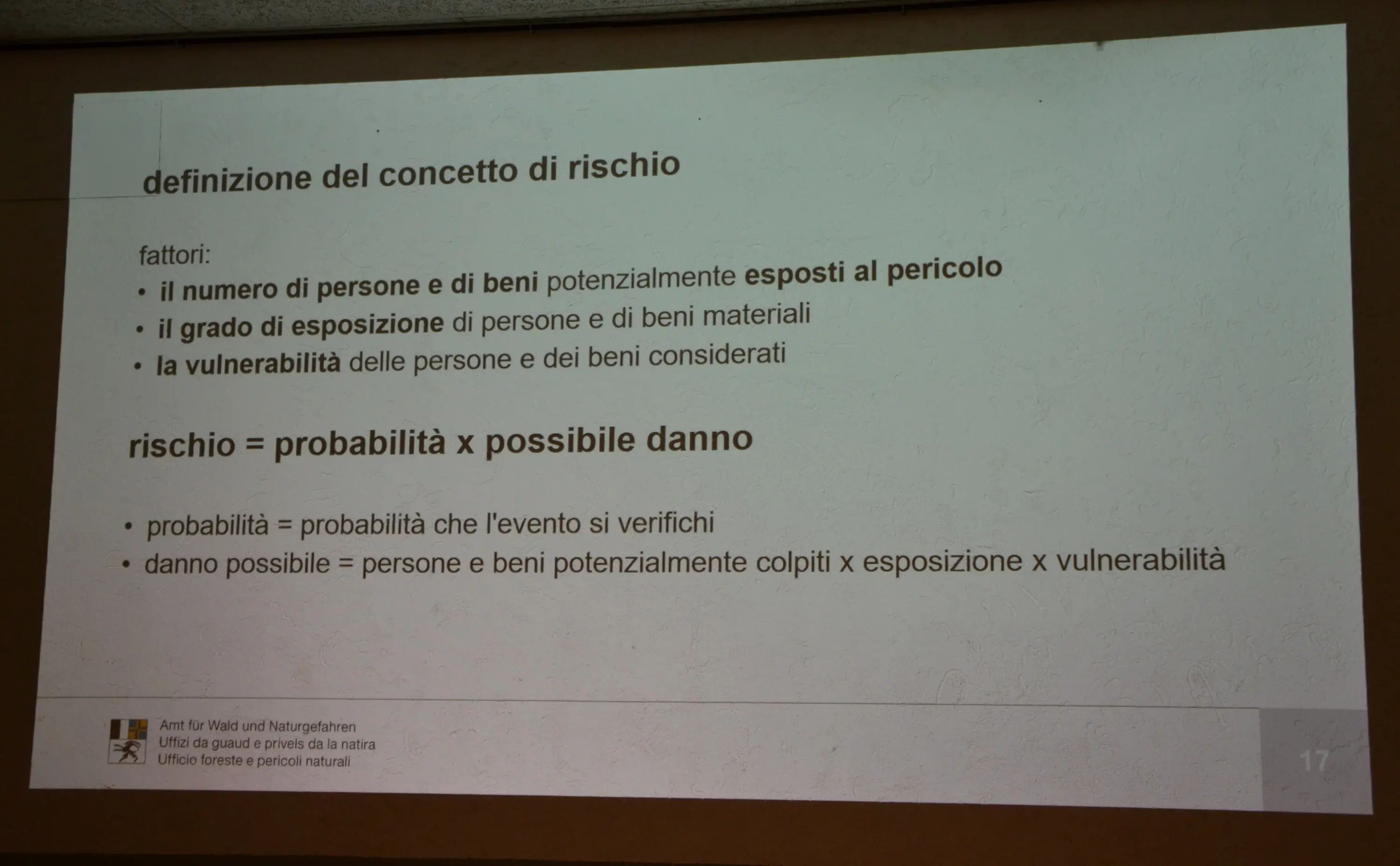 Definizione del concetto di rischio con vari fattori elencati, tra cui numero di persone esposte, grado di esposizione e vulnerabilità. Formula del rischio come probabilità moltiplicata per possibile danno.